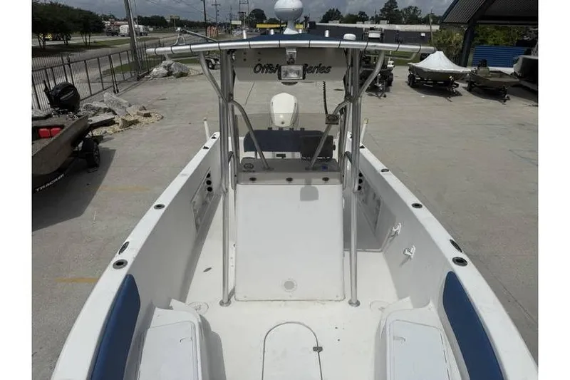 Slide: The Image of 2008 Sea Chaser 2400 CC boat with center console and T-top in a parking area. - 7