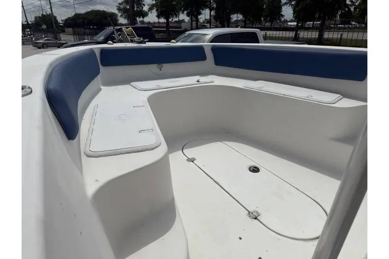 Slide: The Image of 2008 Sea Chaser 2400 CC boat interior with blue seating and storage compartments. - 9