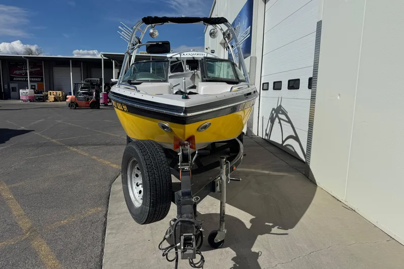Slide: The Image of 2008 Moomba Mobius LS boat on trailer, parked outside a service center. - 4