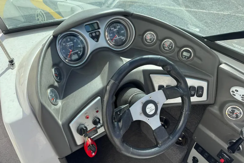 Slide: The Image of 2008 Moomba Mobius LS boat dashboard with steering wheel and gauges. - 6