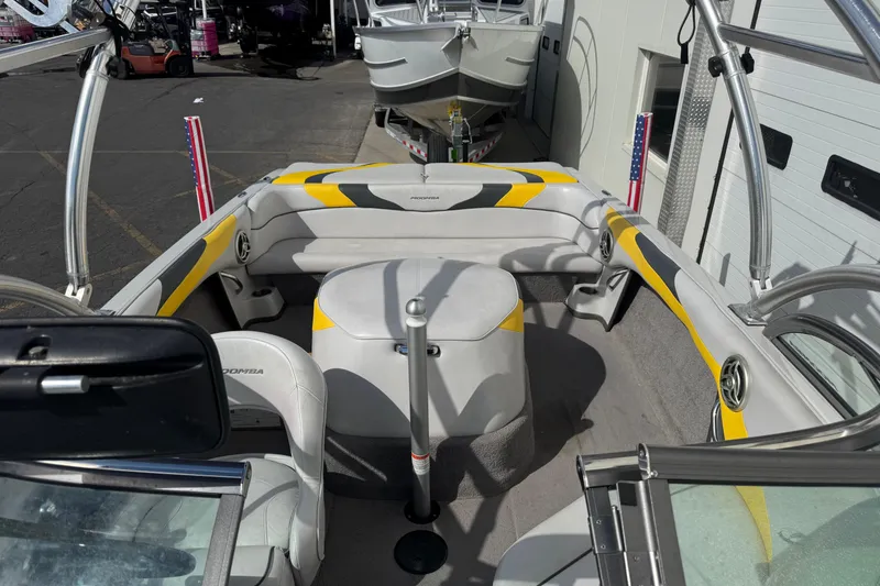 Slide: The Image of 2008 Moomba Mobius LS boat interior with yellow accents and seating arrangement. - 8