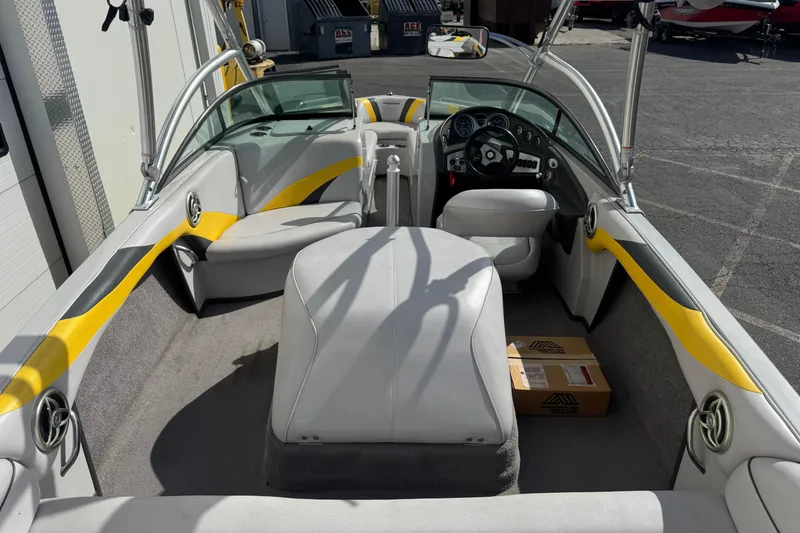Slide: The Image of 2008 Moomba Mobius LS boat interior with yellow accents and seating arrangement. - 9