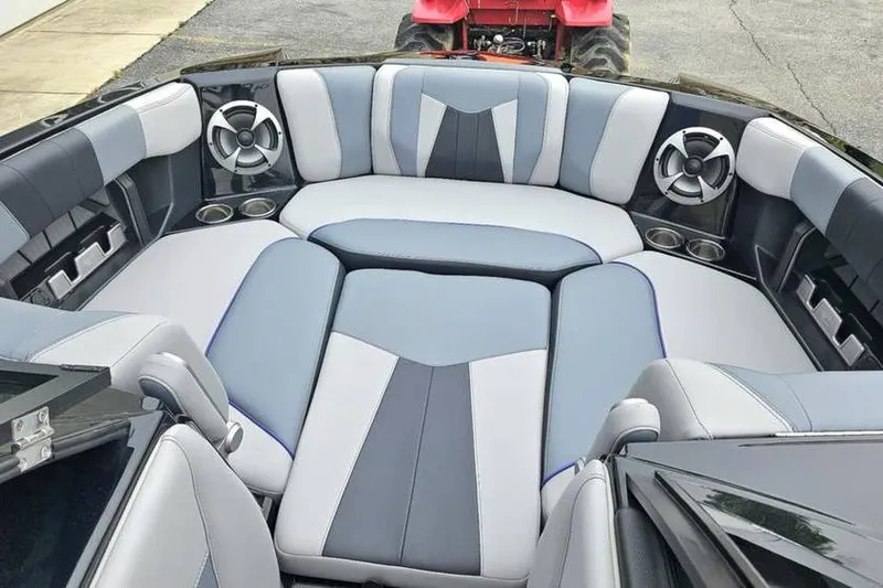Slide: The Image of 2021 Malibu Wakesetter 23 MXZ boat interior with stylish seating and speakers. - 4