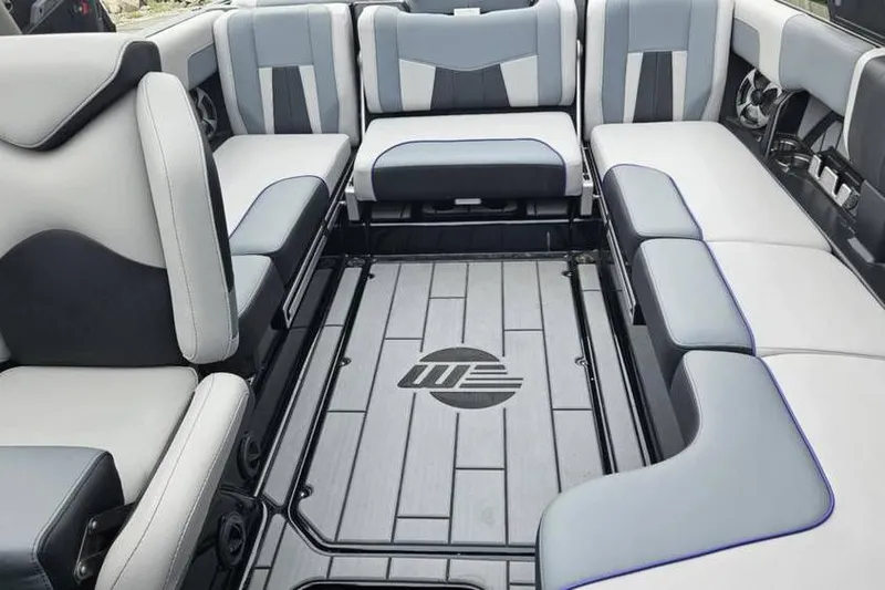 Slide: The Image of 2021 Malibu Wakesetter 23 MXZ interior with stylish seating and logo flooring. - 5
