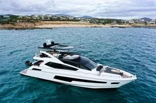 Slide: The Image of Luxurious 2016 Sunseeker 75 Yacht cruising in clear blue waters near a scenic coastline. - 2