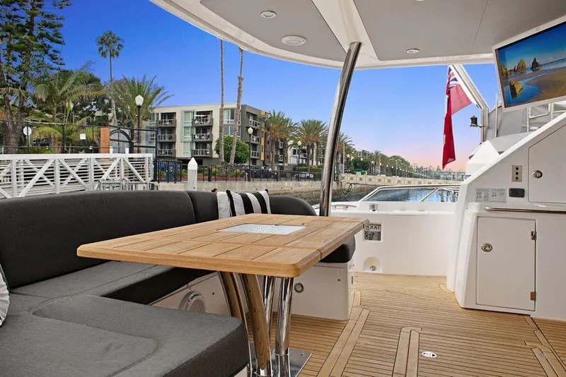 Slide: The Image of Luxurious 2016 Sunseeker 75 Yacht deck with seating, table, and waterfront view. - 29
