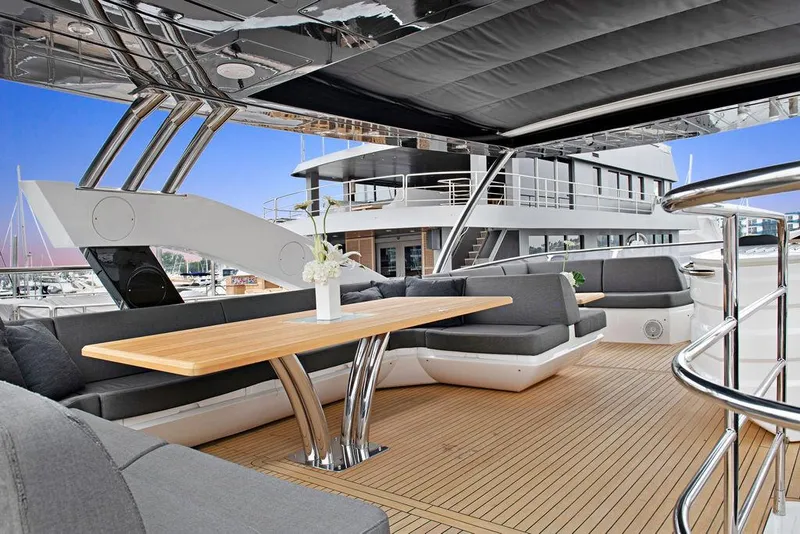 Slide: The Image of Luxurious 2016 Sunseeker 75 Yacht with elegant outdoor seating and wooden deck. - 33