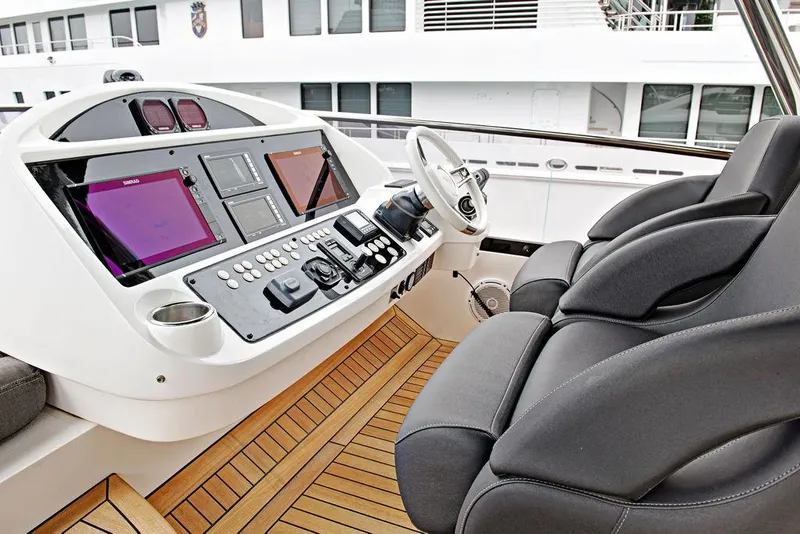 Slide: The Image of Helm of 2016 Sunseeker 75 Yacht with modern navigation controls and plush seating. - 37