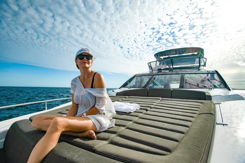 Slide: The Image of Woman relaxing on Sunseeker 75 Yacht, 2016 model, under a partly cloudy sky. - 6