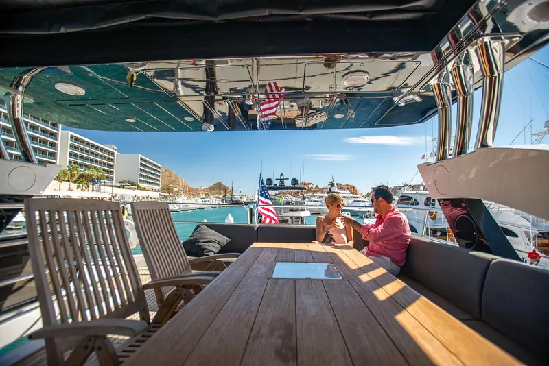 Slide: The Image of Couple relaxing on Sunseeker 75 Yacht, 2016 model, in a sunny marina setting. - 9