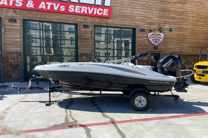The Image of 2023 Tahoe T16 boat on trailer outside service center. - 0
