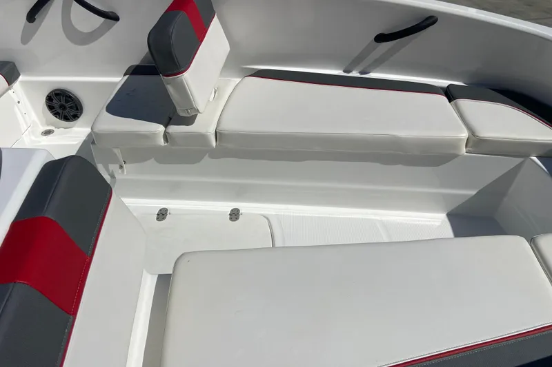 Slide: The Image of 2023 Tahoe T16 boat interior with white and red cushioned seating. - 7