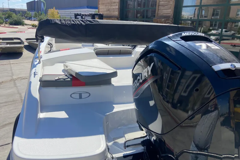Slide: The Image of 2023 Tahoe T16 boat with Mercury engine, docked outdoors in sunlight. - 8