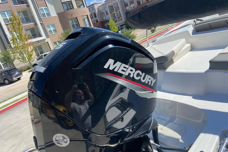 Slide: The Image of 2023 Tahoe T16 boat with Mercury outboard motor in urban setting. - 9