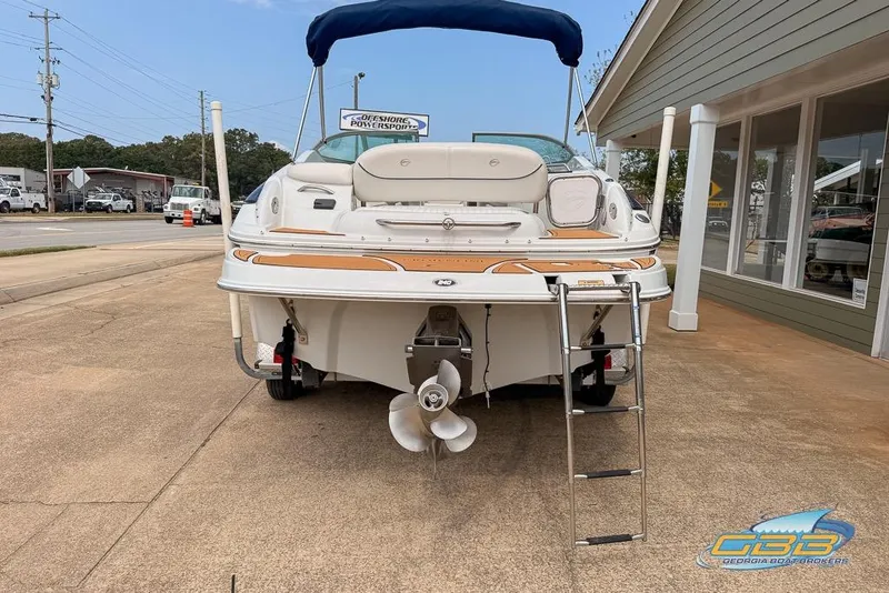 Slide: The Image of 2004 Crownline 240 EX boat with ladder and propeller, parked outside a building. - 10