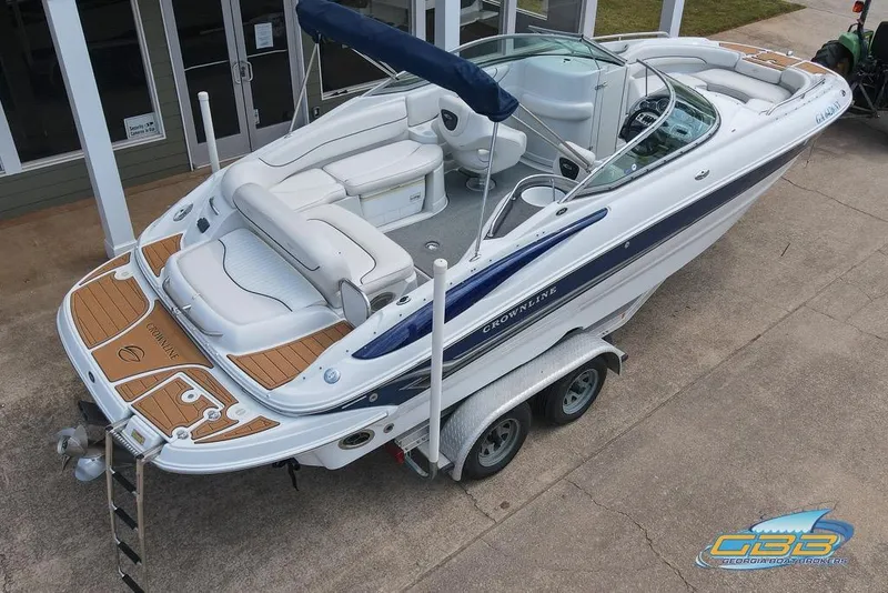 Slide: The Image of 2004 Crownline 240 EX boat on trailer, featuring spacious seating and sleek design. - 14