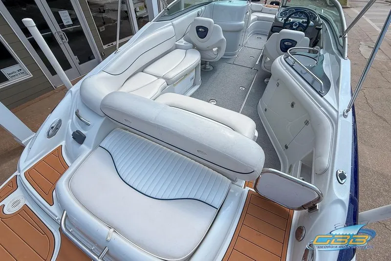 Slide: The Image of 2004 Crownline 240 EX boat interior with white seating and modern dashboard. - 16