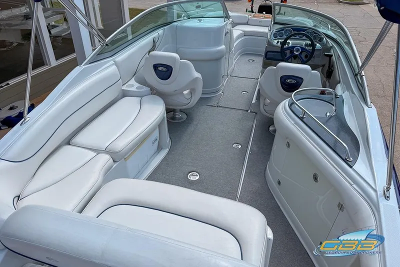 Slide: The Image of 2004 Crownline 240 EX boat interior with white seating and modern dashboard. - 17