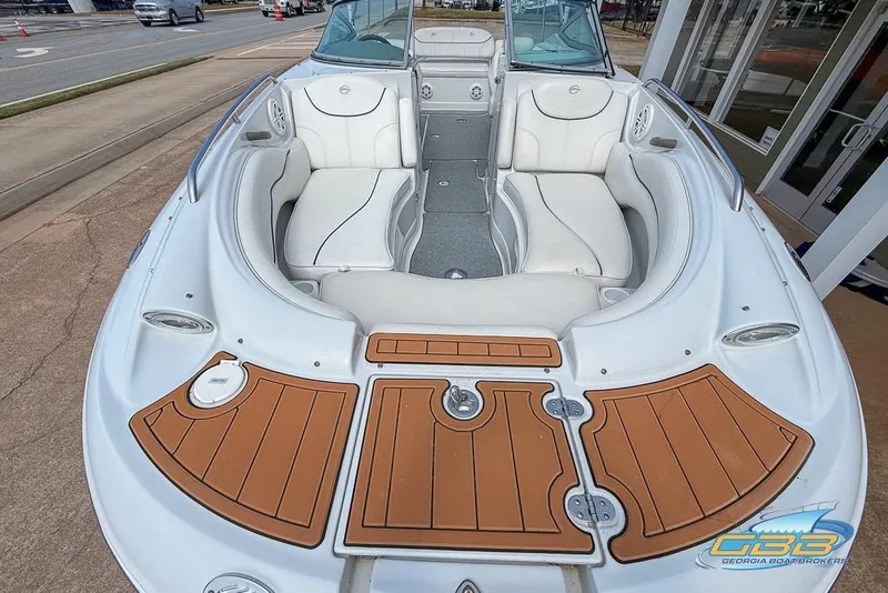 Slide: The Image of 2004 Crownline 240 EX boat with spacious seating and stylish wood accents. - 18