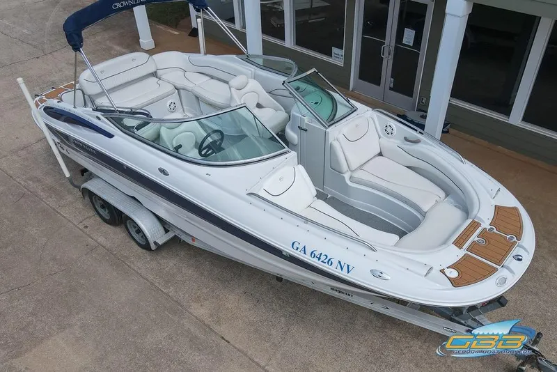 Slide: The Image of 2004 Crownline 240 EX boat on trailer, featuring spacious seating and sleek design. - 19