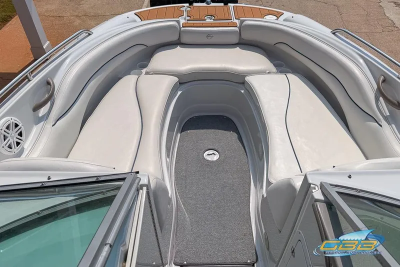 Slide: The Image of 2004 Crownline 240 EX boat interior with white seating and gray flooring. - 23