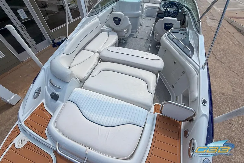 Slide: The Image of 2004 Crownline 240 EX boat interior with white seating and wood accents. - 25