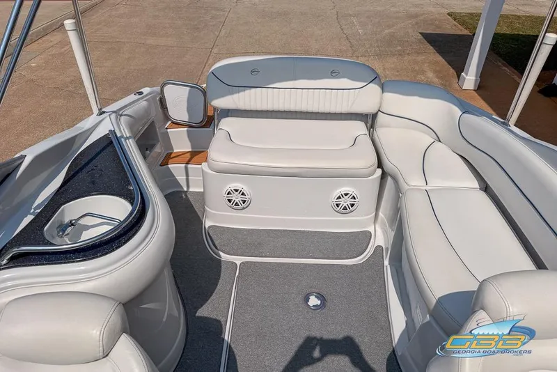 Slide: The Image of 2004 Crownline 240 EX boat interior with white seating and built-in speakers. - 30