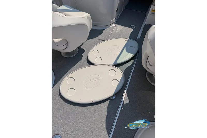 Slide: The Image of 2004 Crownline 240 EX boat interior with seating and storage compartments. - 32