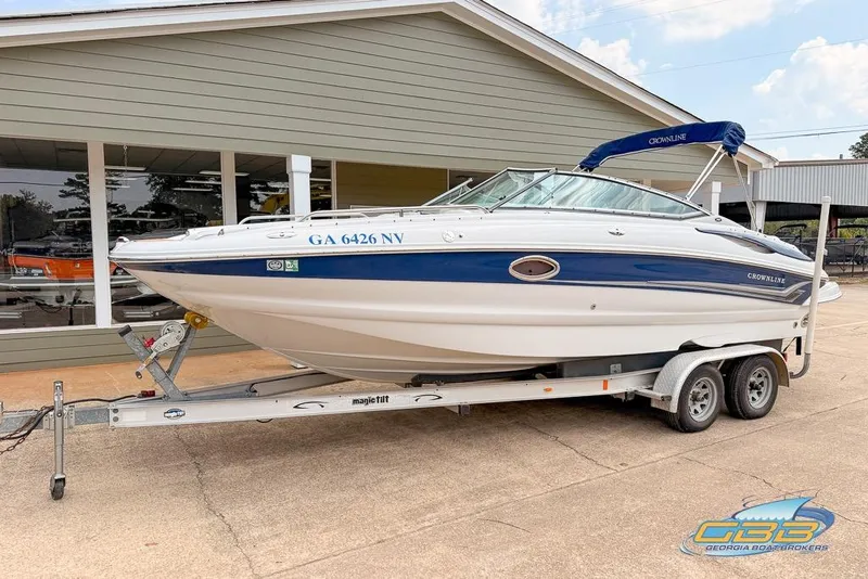 Slide: The Image of 2004 Crownline 240 EX boat on trailer, parked outside a building. - 6