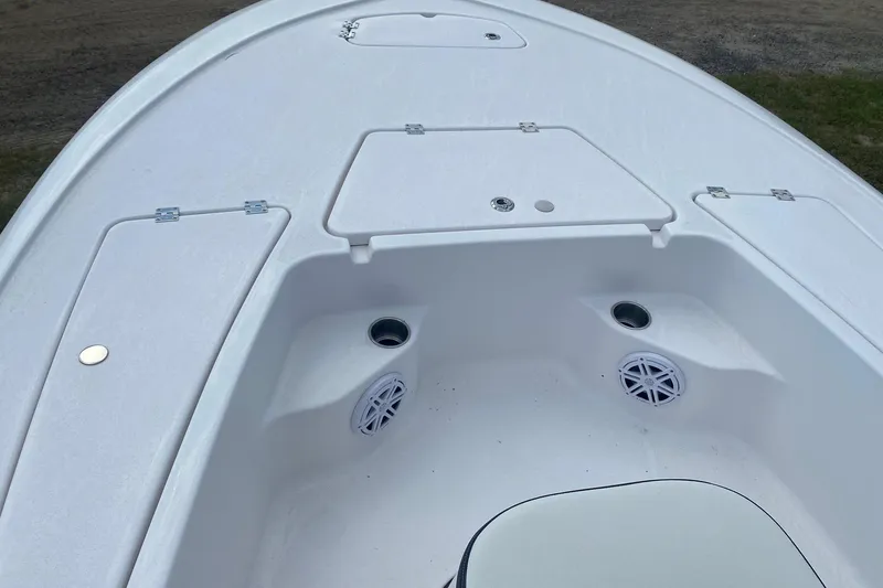 Slide: The Image of 2024 Tidewater 1910 Bay Max boat deck with storage compartments and speakers. - 2