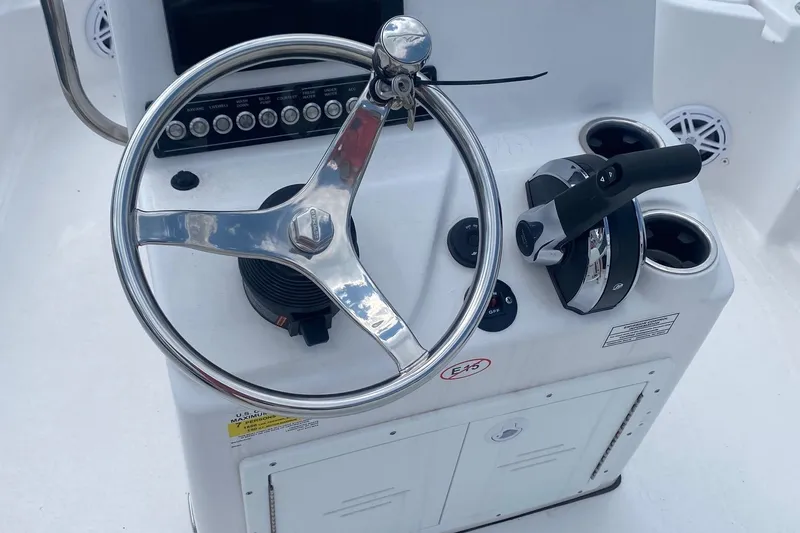 Slide: The Image of Steering console of 2024 Tidewater 1910 Bay Max boat with controls and cup holders. - 4