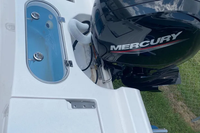 Slide: The Image of 2024 Tidewater 1910 Bay Max boat with Mercury engine, featuring livewell and sleek design. - 6