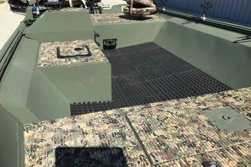 Slide: The Image of 2001 Lowe Roughneck 1860SC boat interior with camouflage design and black flooring. - 16