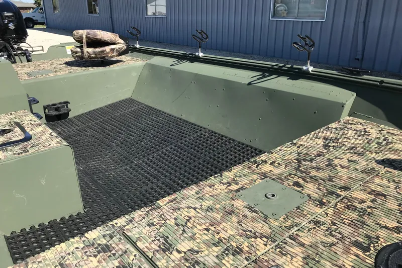 Slide: The Image of 2001 Lowe Roughneck 1860SC boat with camouflage deck and fishing rod holders. - 17