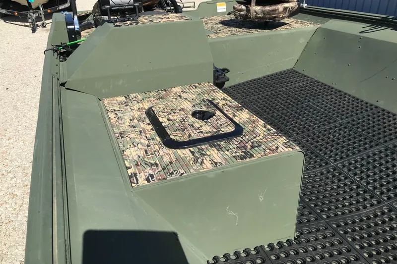 Slide: The Image of 2001 Lowe Roughneck 1860SC boat interior with camouflage seating and textured flooring. - 18