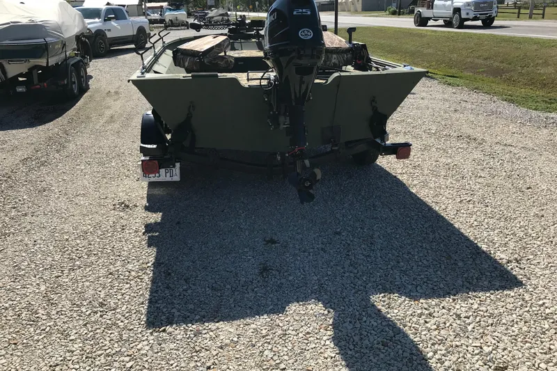 Slide: The Image of 2001 Lowe Roughneck 1860SC boat with outboard motor on gravel lot. - 5