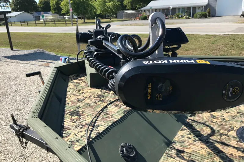 Slide: The Image of 2001 Lowe Roughneck 1860SC boat with Minn Kota Terrova trolling motor, parked on gravel. - 7