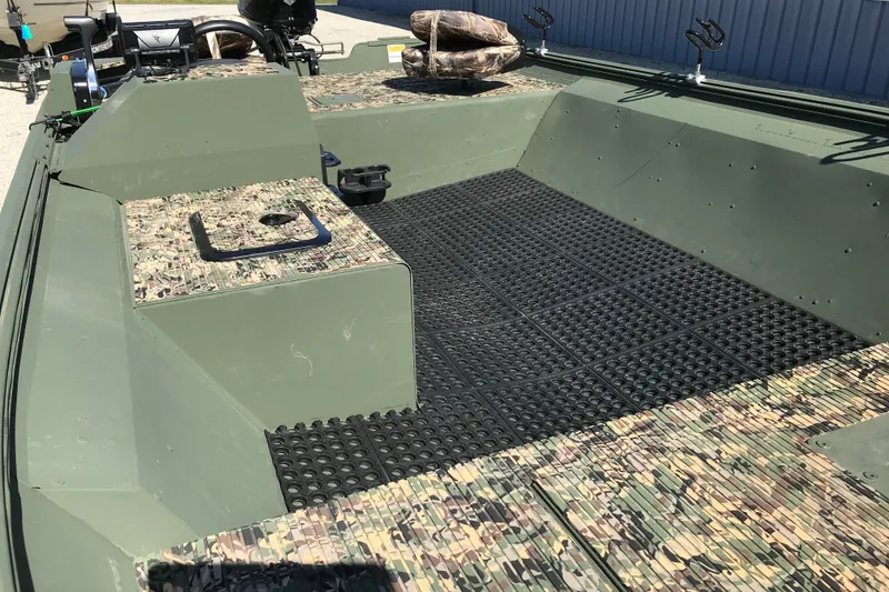 Slide: The Image of 2001 Lowe Roughneck 1860SC boat interior with camouflage seating and non-slip flooring. - 8