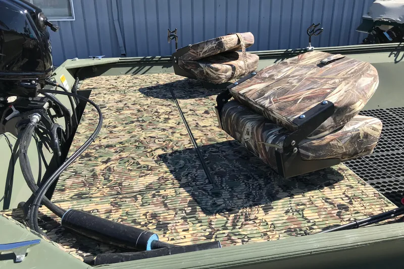 Slide: The Image of 2001 Lowe Roughneck 1860SC boat with camouflage seats and flooring. - 9