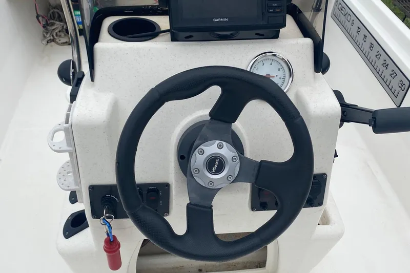 Slide: The Image of Steering console of a 2015 Mako 171 Center Console boat with Garmin GPS. - 5