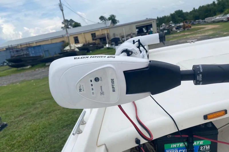 Slide: The Image of Minn Kota Riptide motor on 2015 Mako 171 Center Console boat, outdoor setting. - 8