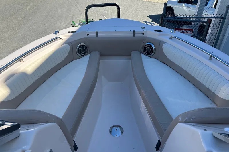 Slide: The Image of 2013 Grady-White Freedom 255 boat interior with cushioned seating and speakers. - 3