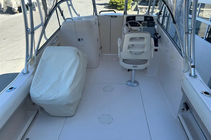 Slide: The Image of 2013 Grady-White Freedom 255 boat interior with helm and seating area. - 4
