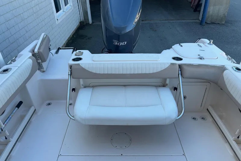 Slide: The Image of 2013 Grady-White Freedom 255 boat interior with seating and Yamaha 300 engine. - 6