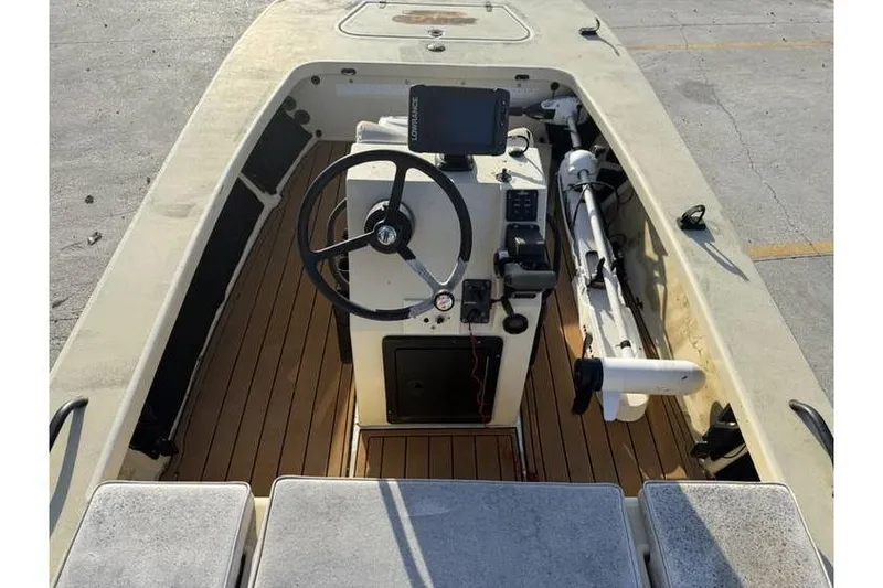 Slide: The Image of 2003 Buskens 17 Flats boat interior with steering wheel and navigation equipment. - 7