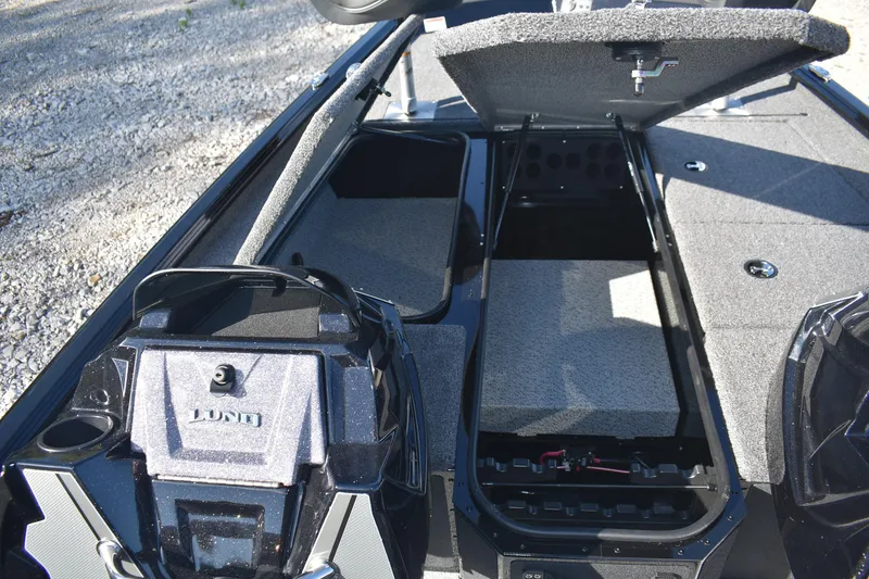 Slide: The Image of 2026 Lund 1875 Renegade boat interior with steering wheel and seating. - 12