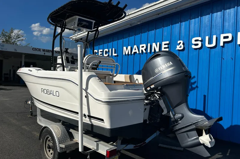 Slide: The Image of 2018 Robalo R180 Center Console boat with Yamaha engine at marine supply store. - 2