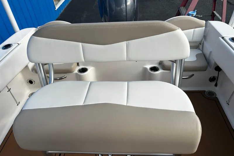 Slide: The Image of 2018 Robalo R180 Center Console boat seating, beige and white upholstery. - 20