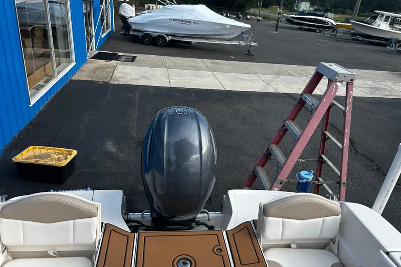 Slide: The Image of 2018 Robalo R180 Center Console boat with Yamaha outboard motor in a marina setting. - 26