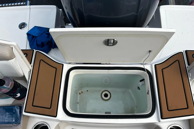 Slide: The Image of 2018 Robalo R180 Center Console boat with open storage compartment and accessories. - 28